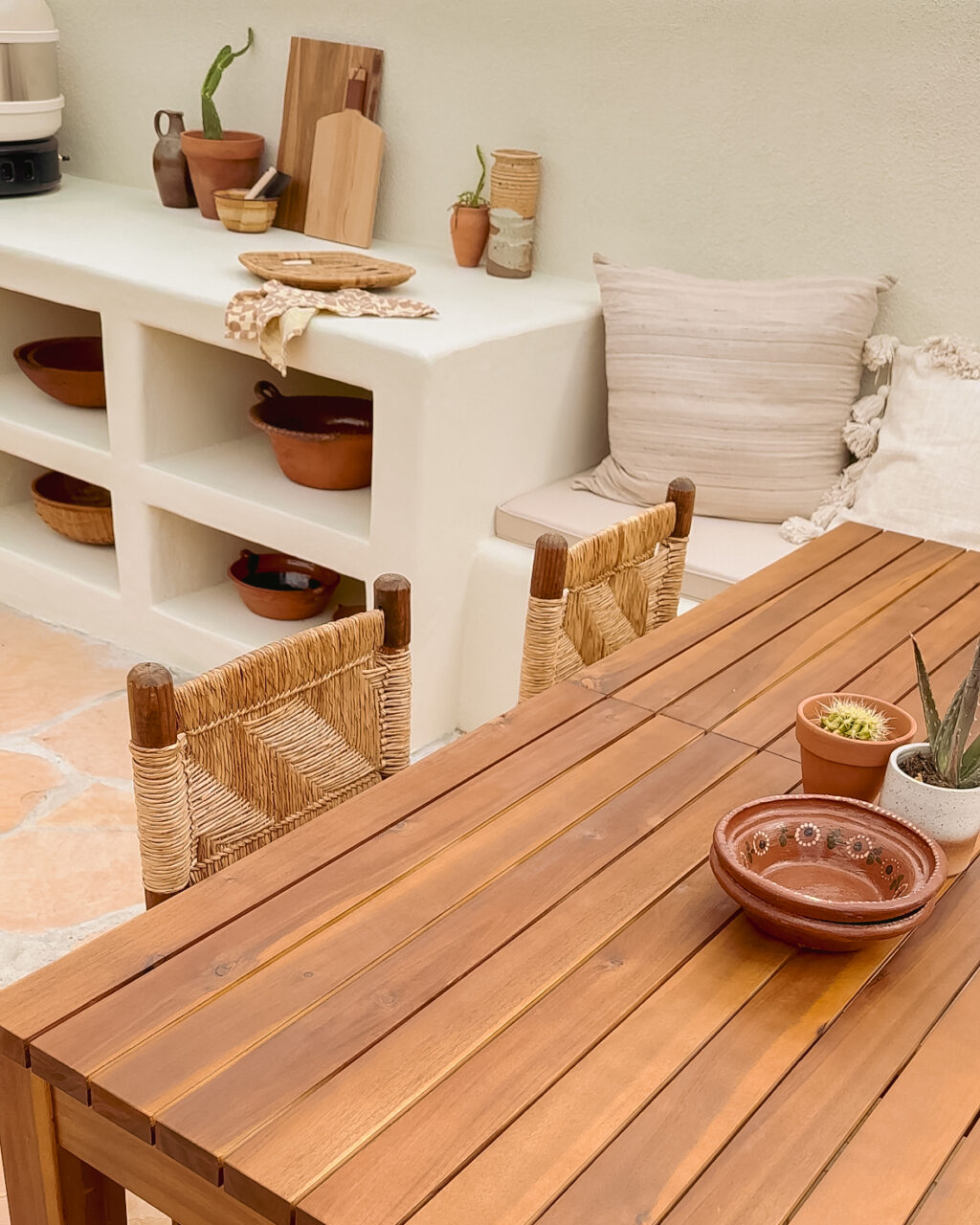 outdoor kitchen - stucco Mediterranean style - southwest desert backyard - wooden table and woven chairs